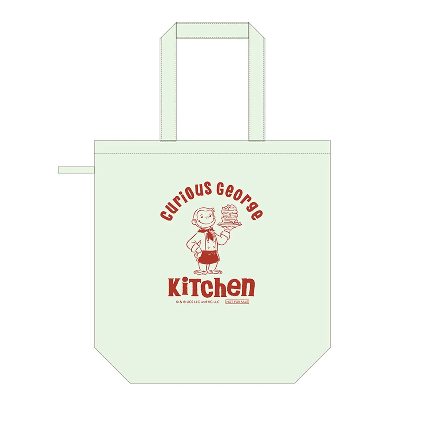 おさるのジョージのイラストが描かれた薄いグリーンのトートバッグ