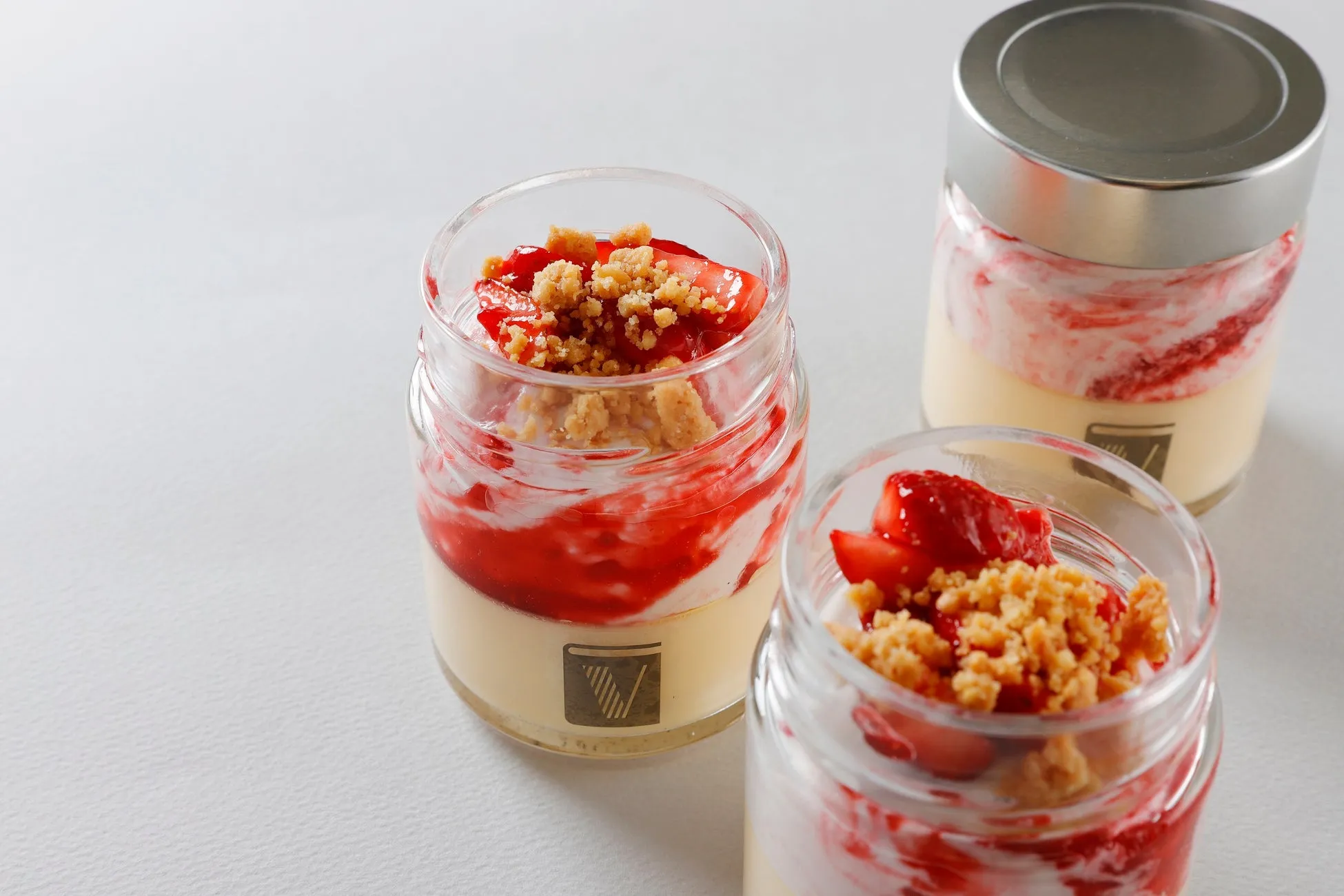 ガラス瓶に入ったイチゴとクリームのデザート