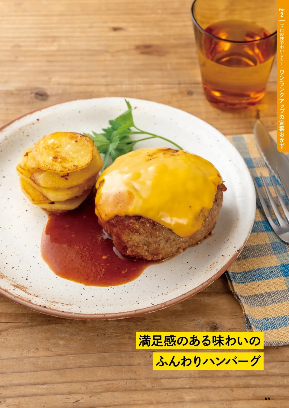 チーズが乗ったハンバーグとポテト、ソースが添えられた料理