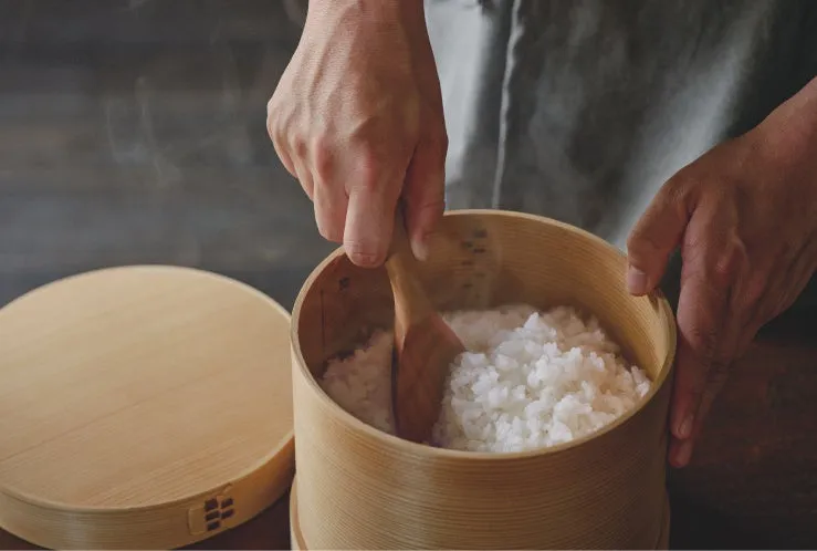 木製の桶にご飯をよそっている様子