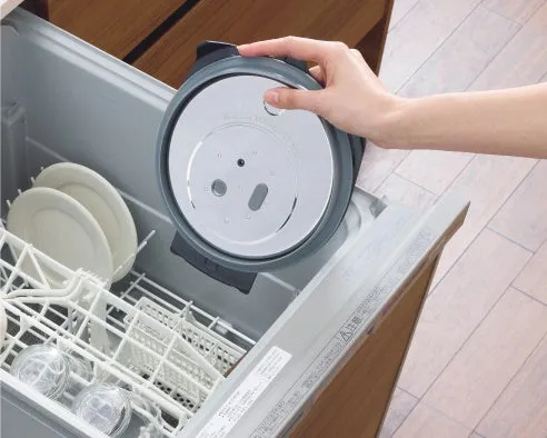 食器洗い機から取り外された蓋を持つ手。