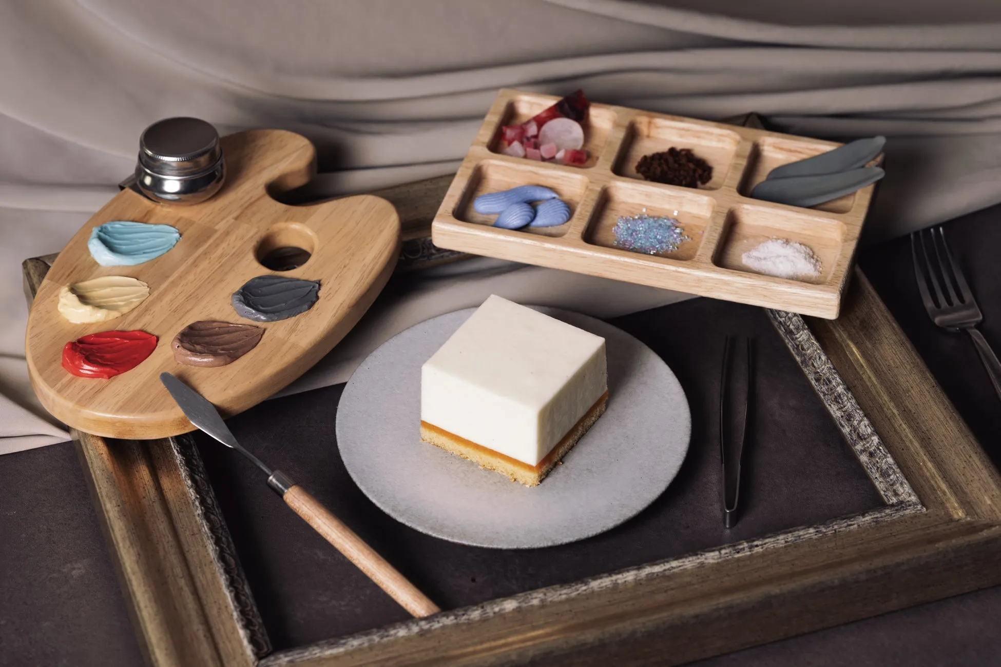 絵の具のパレットと、ケーキ、食材を並べた写真