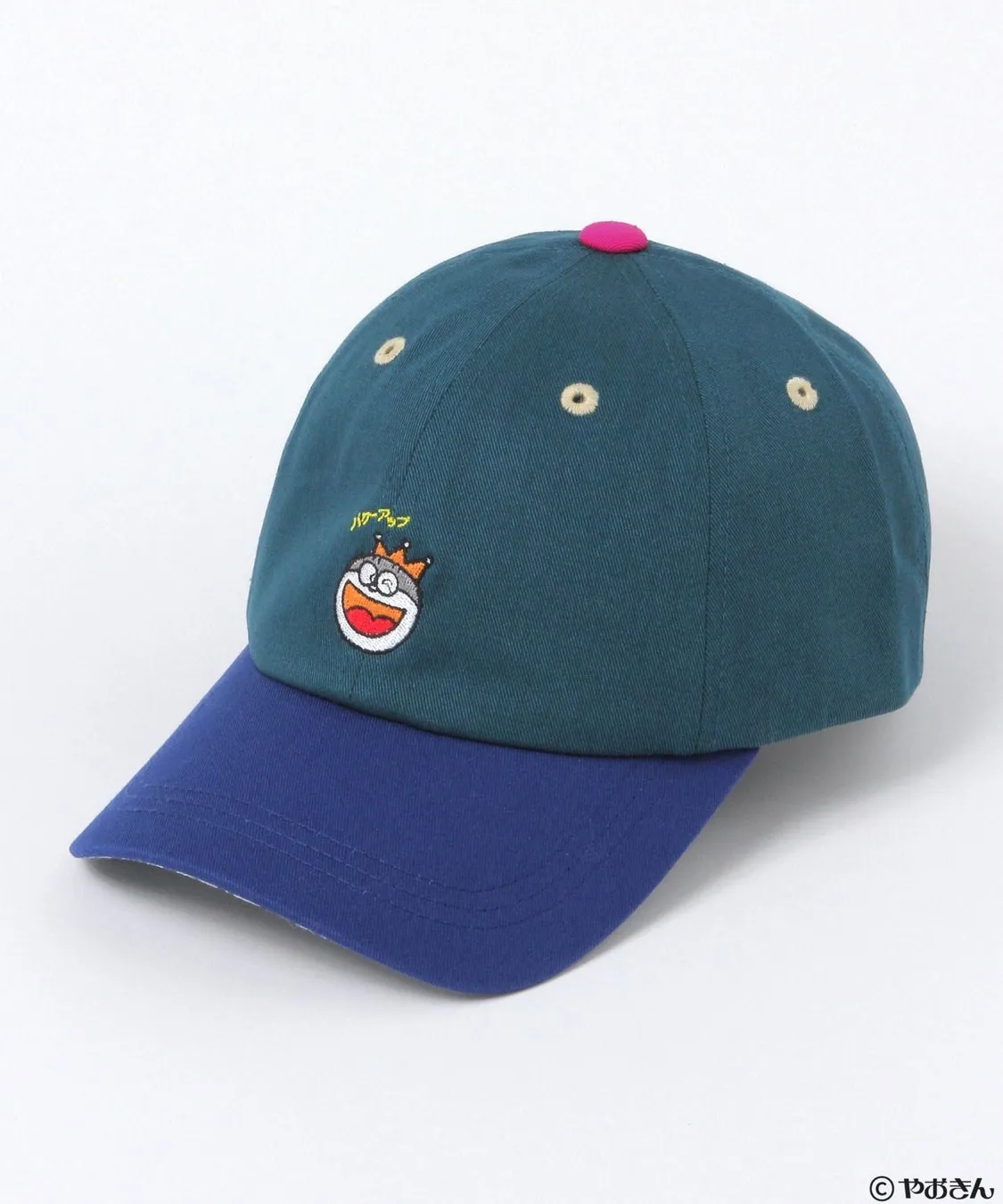緑と青のツートンカラーの野球帽。帽子の正面には王冠を被ったキャラクターの刺繍があり、その上には「ハゲアップ」の文字が刺繍されています。