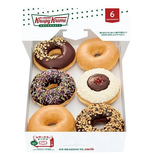 Krispy Kreme のドーナツが6つ入った箱の写真です。様々なトッピングが施されたドーナツが並んでいます。