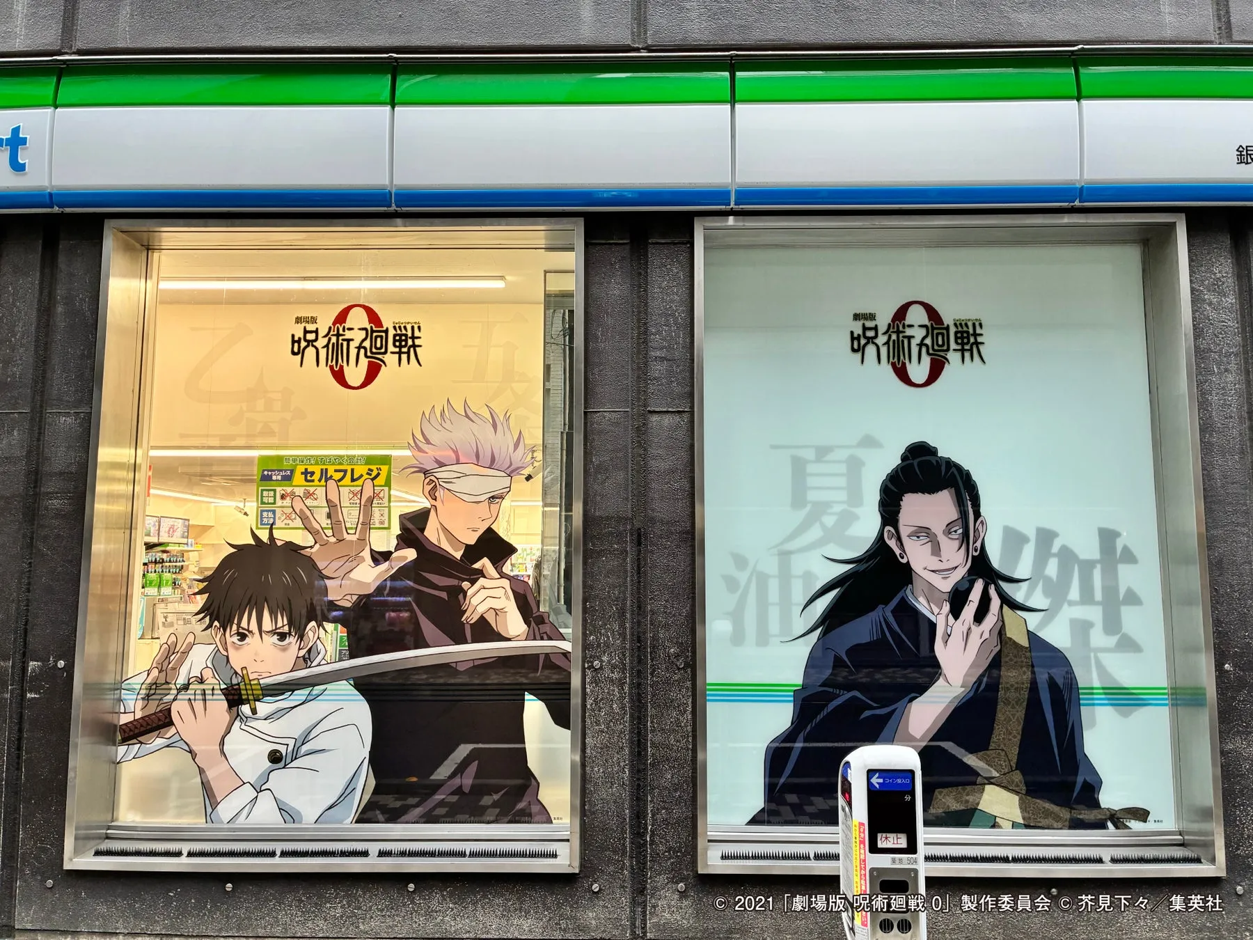 アニメ「呪術廻戦」の広告が掲載されたコンビニの窓の写真。左側の窓には、刀を持つキャラクターと、目隠しをしたキャラクターが描かれている。右側の窓には、長い黒髪のキャラクターが描かれている。