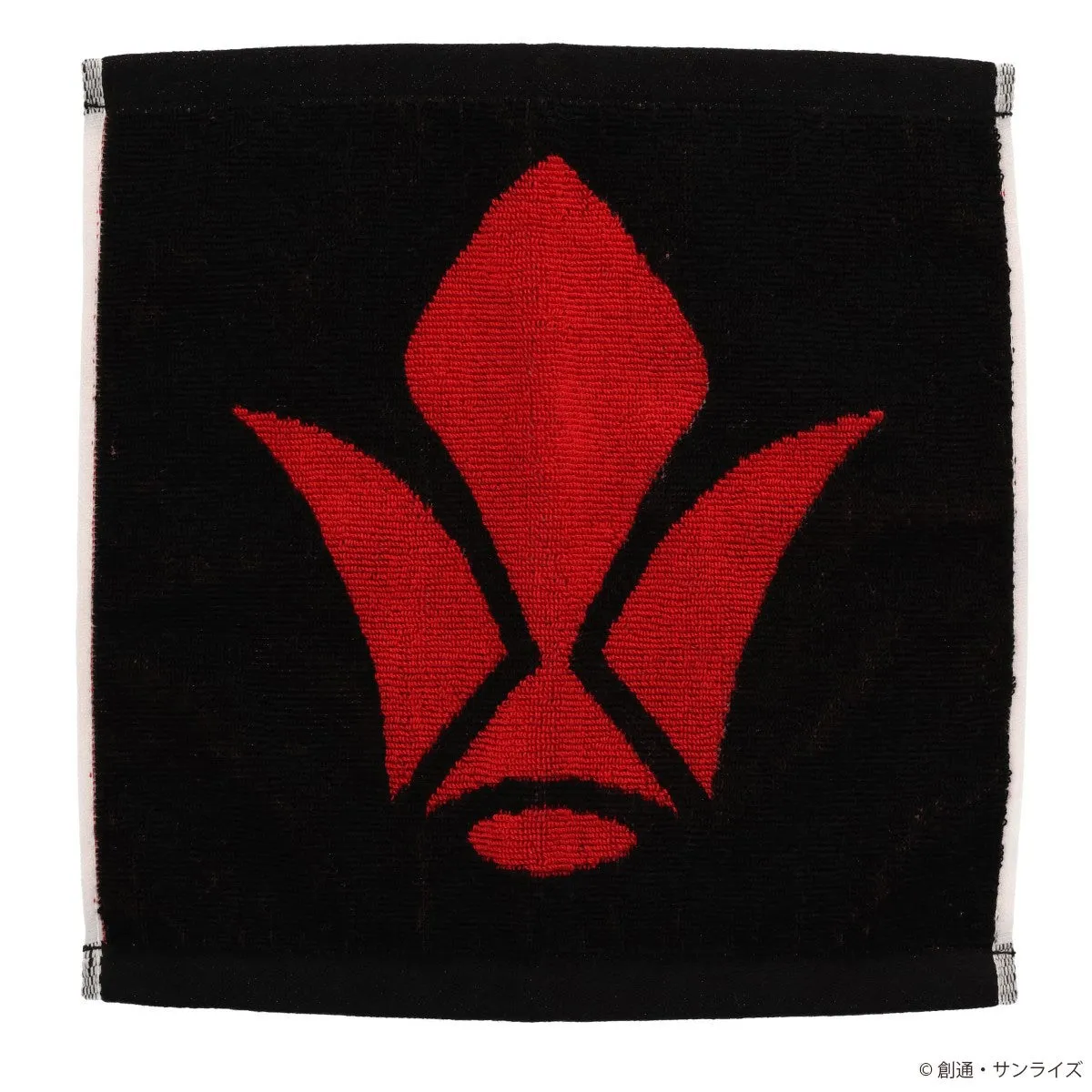 黒地に赤いマークが描かれたタオル。マークは中央に大きな花のようなデザインで、その周りを囲むように葉のような形が配置されている。