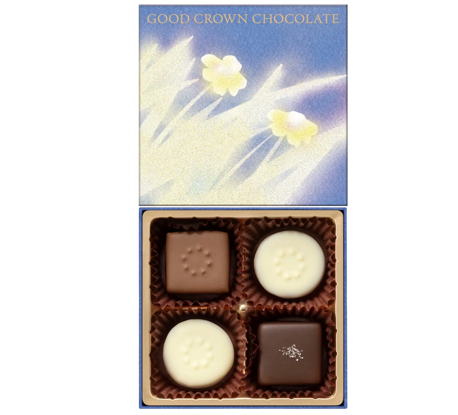 チョコレートの箱の写真。箱には4つのチョコレートが入っており、白い花のような模様が描かれた蓋が付いています。