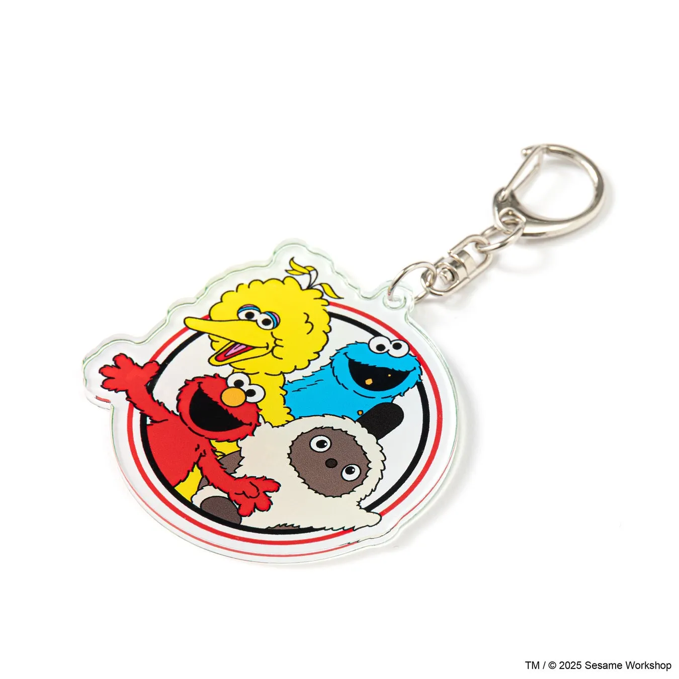 セサミストリートのキャラクターが描かれたキーホルダー。エルモ、クッキーモンスター、ビッグバード、そしてひつじのようなキャラクターが円形に配置されている。