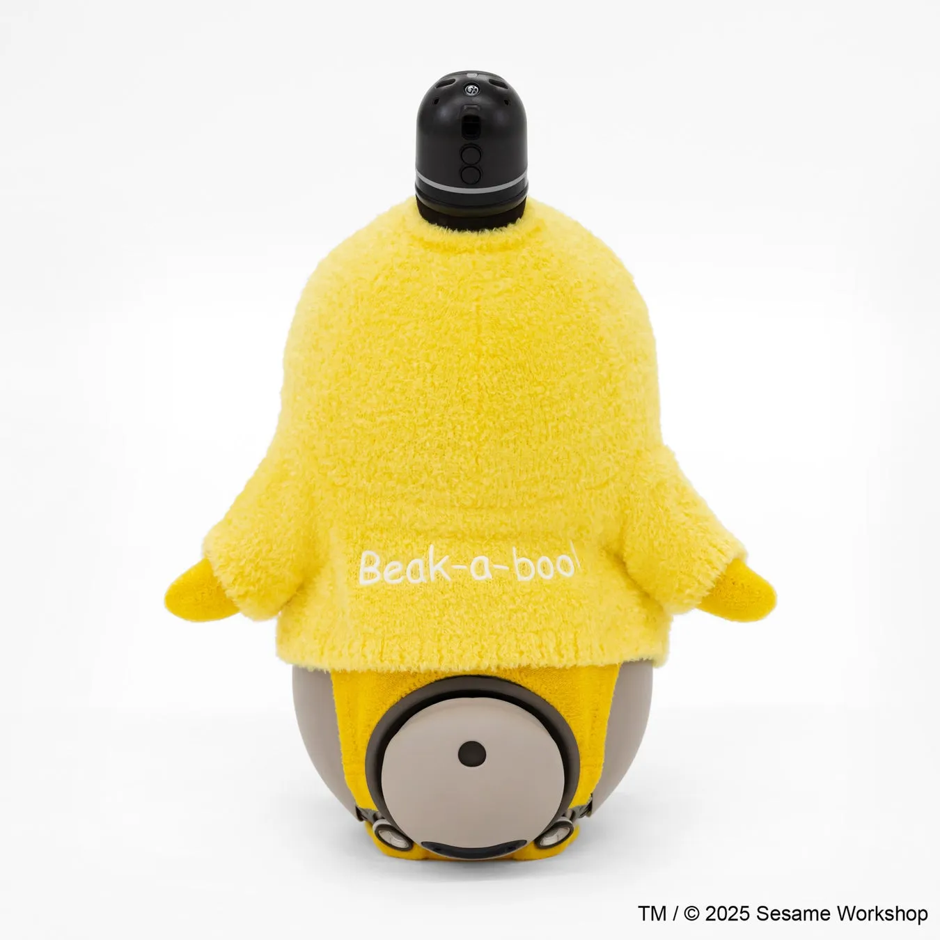 黄色いセサミストリートのキャラクター、Beak-a-booのぬいぐるみ。黒い頭部と黄色い服を着ています。