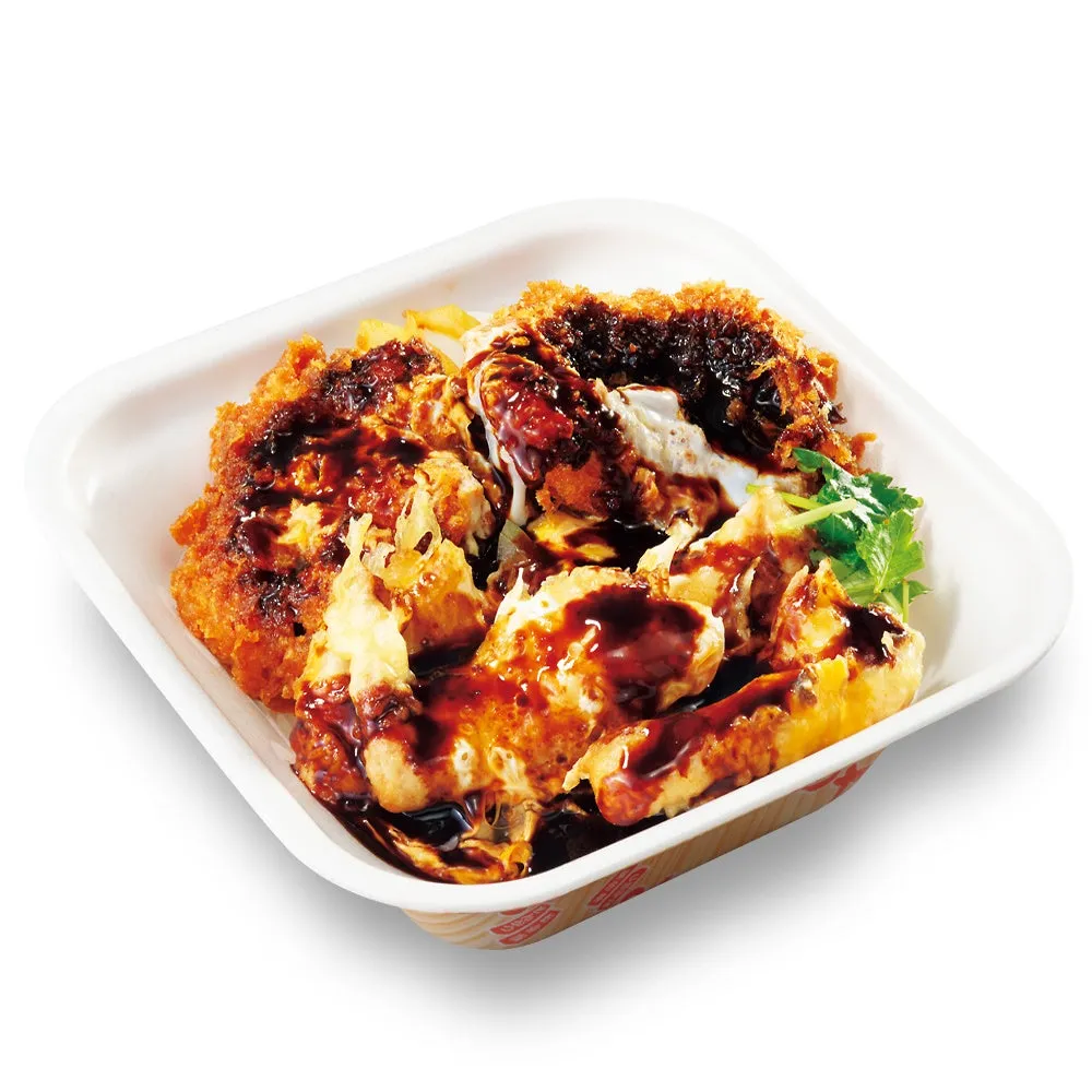 揚げたカツに卵とソースがかかった料理のアップ。白い容器に入っている。