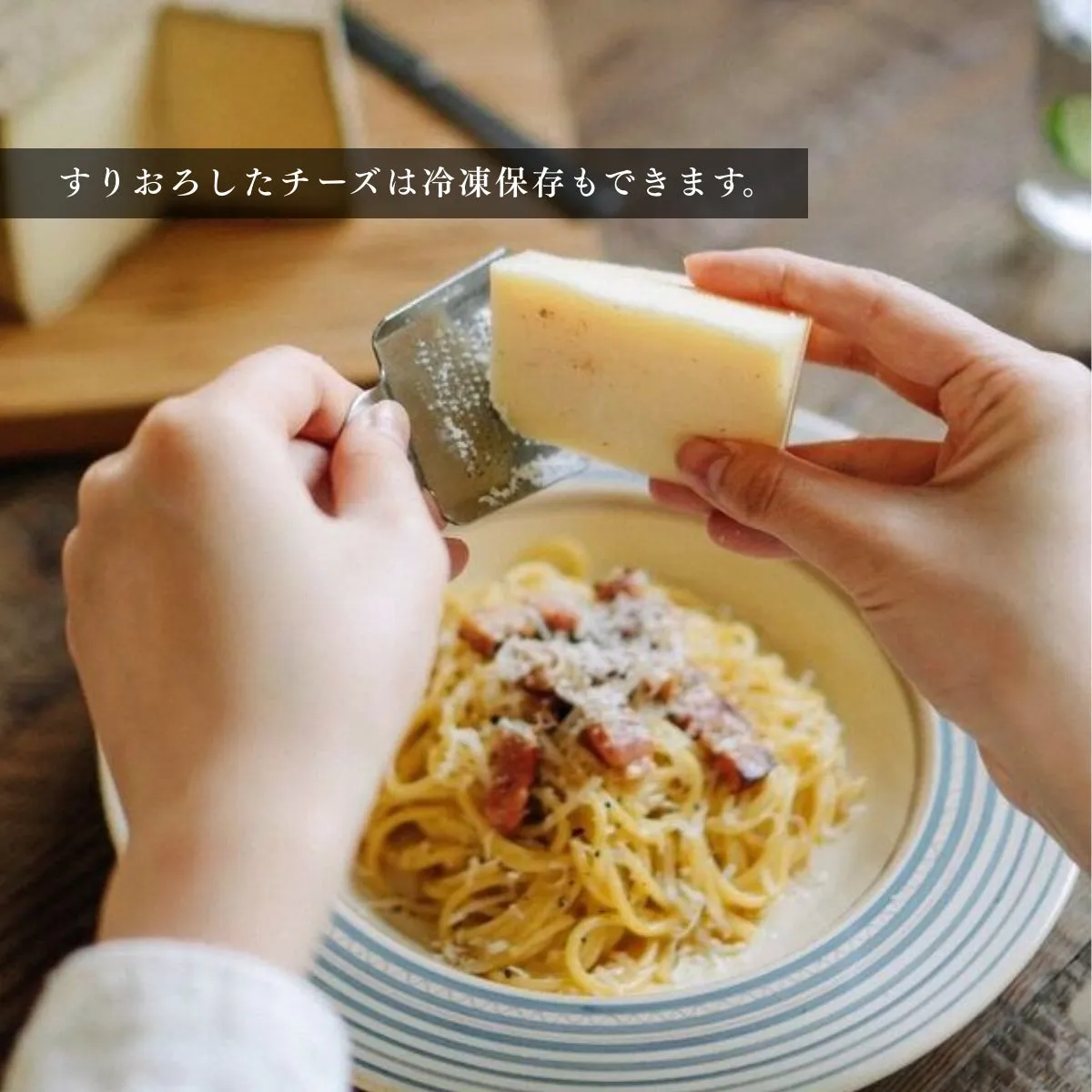 パスタにチーズをすりおろす様子