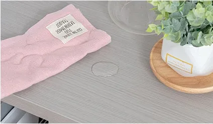 ピンク色の布と水滴、植物が置かれた机