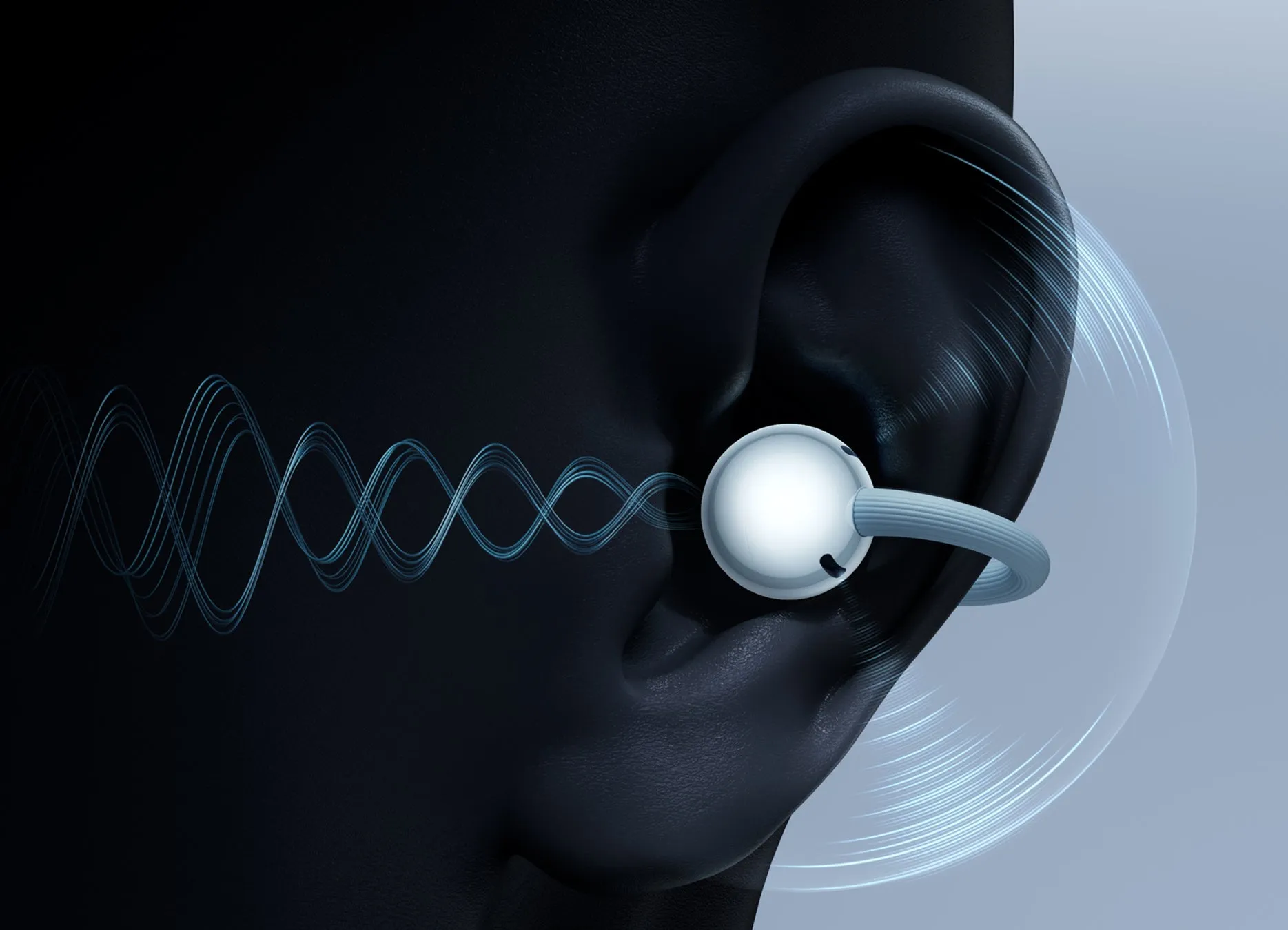 人間の耳のクローズアップ写真。耳にはイヤホンが装着され、音波の視覚化が示されています。