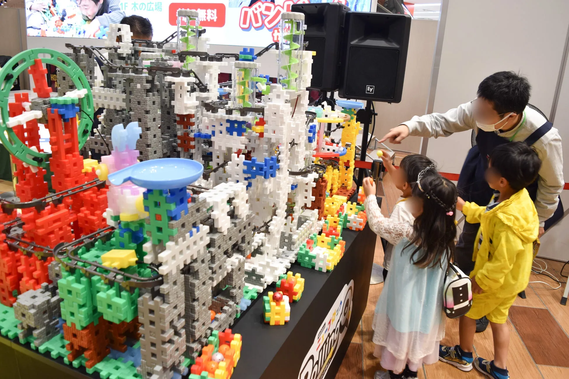 子供たちがブロックで作られた大きな構造物で遊んでいる様子