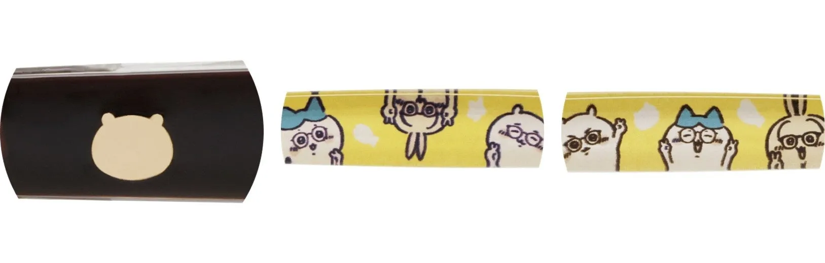 クマのシルエットの模様が入ったケースと、メガネをかけたキャラクターが描かれた黄色のテープが写っています。