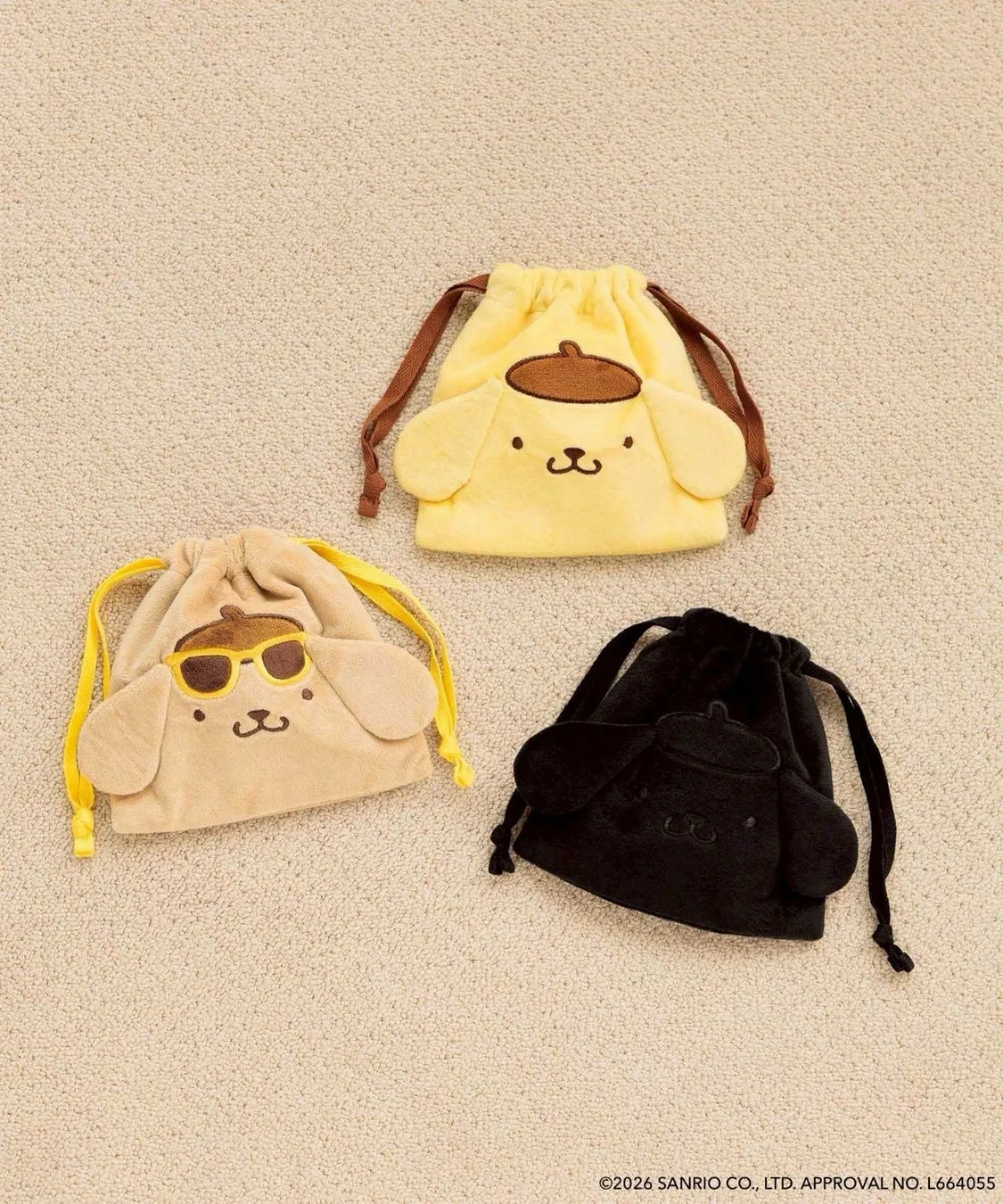 3つのポムポムプリンの巾着が写った写真。色はそれぞれ黄色、ベージュ、黒。