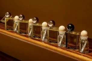 木製の台に並んだ美しい香水瓶のクローズアップ