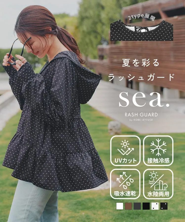 女性が日よけの服を着てポーズをとっている画像です。水玉模様の服を着ており、サングラスを持っています。画像には、UVカット、接触冷感、吸水速乾、水陸両用などのタグも表示されています。