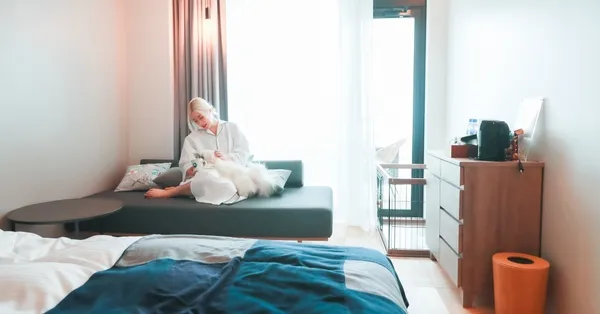 愛犬と宿泊施設でくつろぐ女性